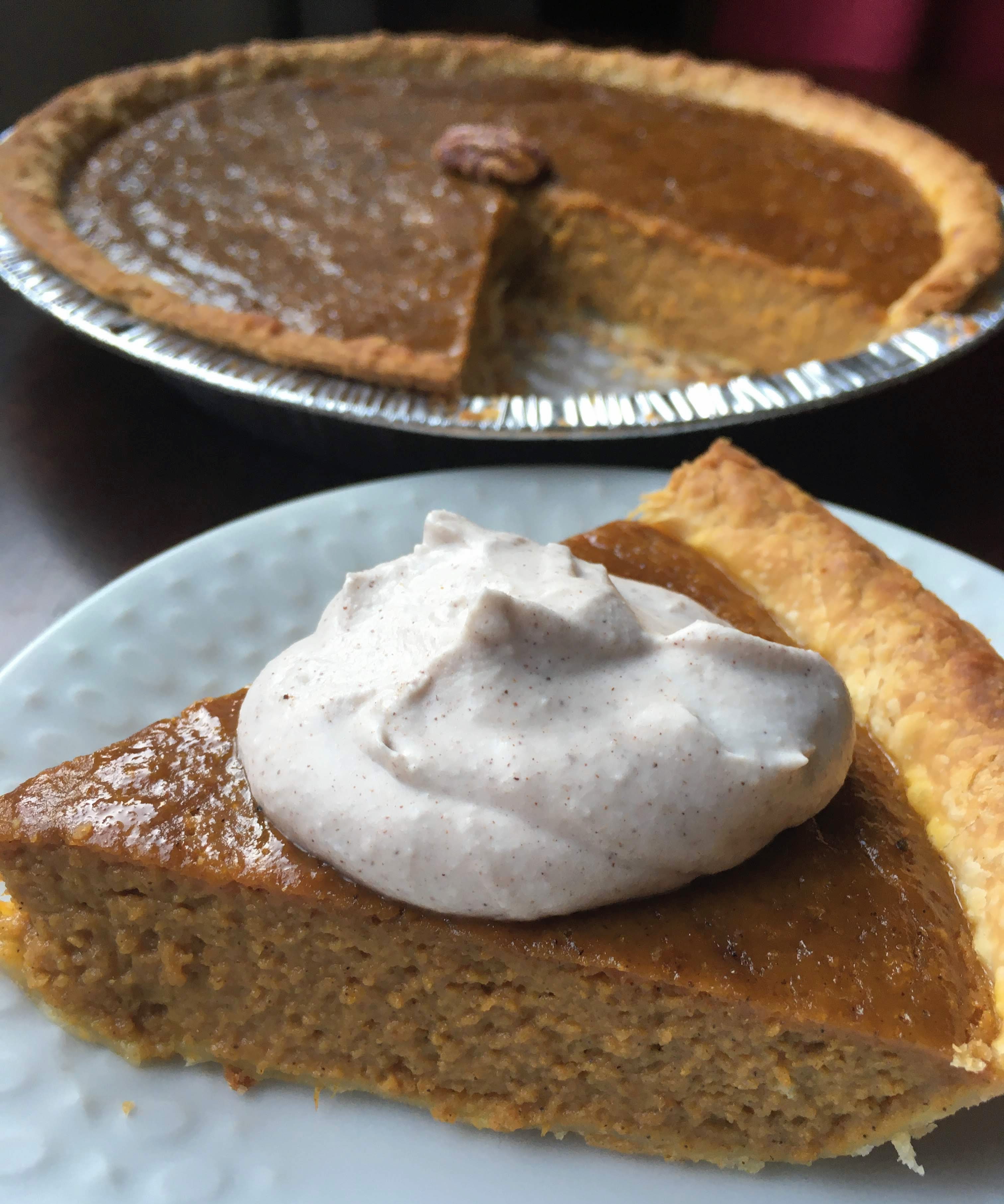 dairy free pumpkin pie made with coconut milk and topped with pumpkin spice coconut whip